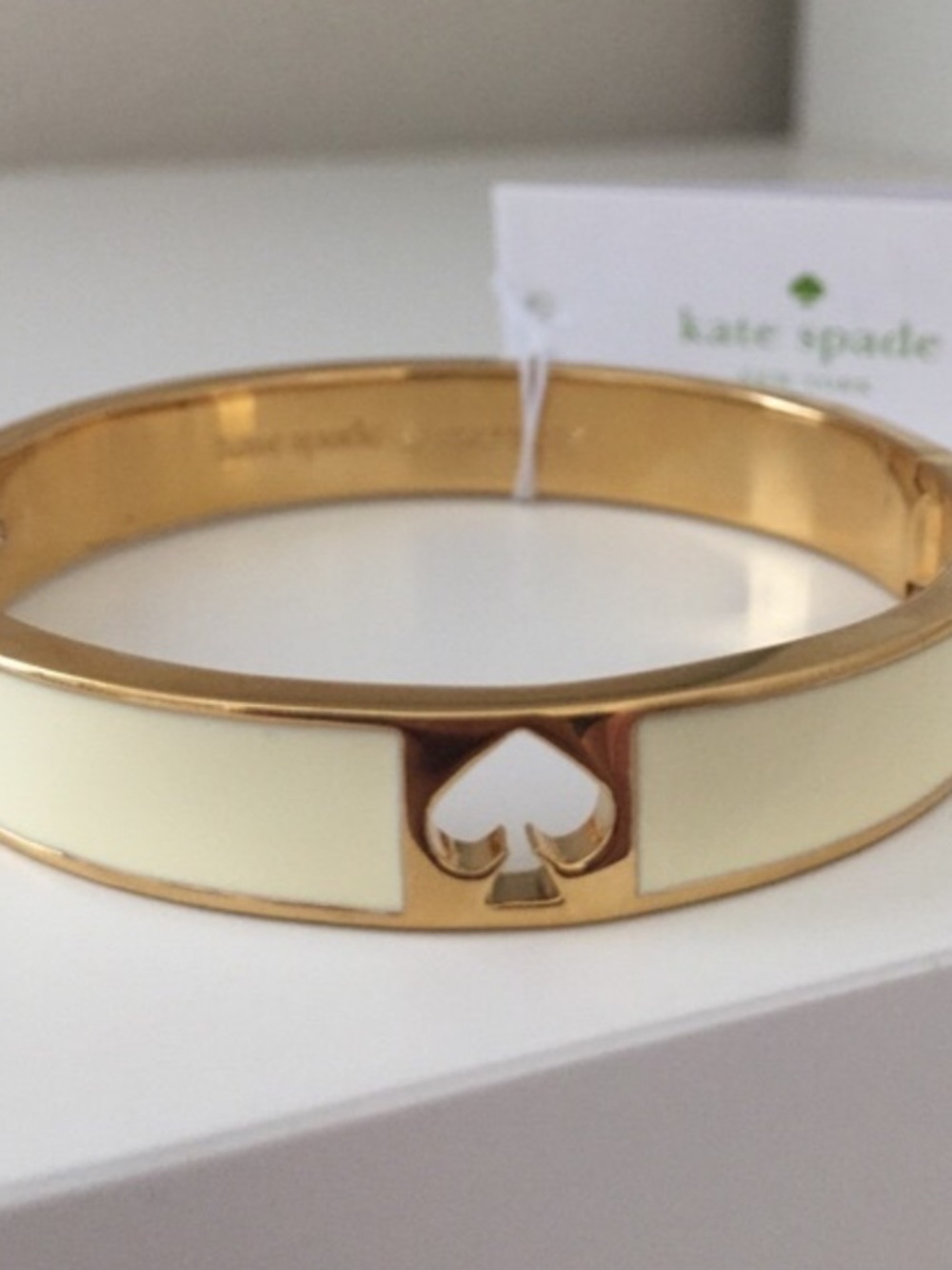 kate spade gold-tone and white enamel spade cutout bangle bracelet - Picture 3 of 3